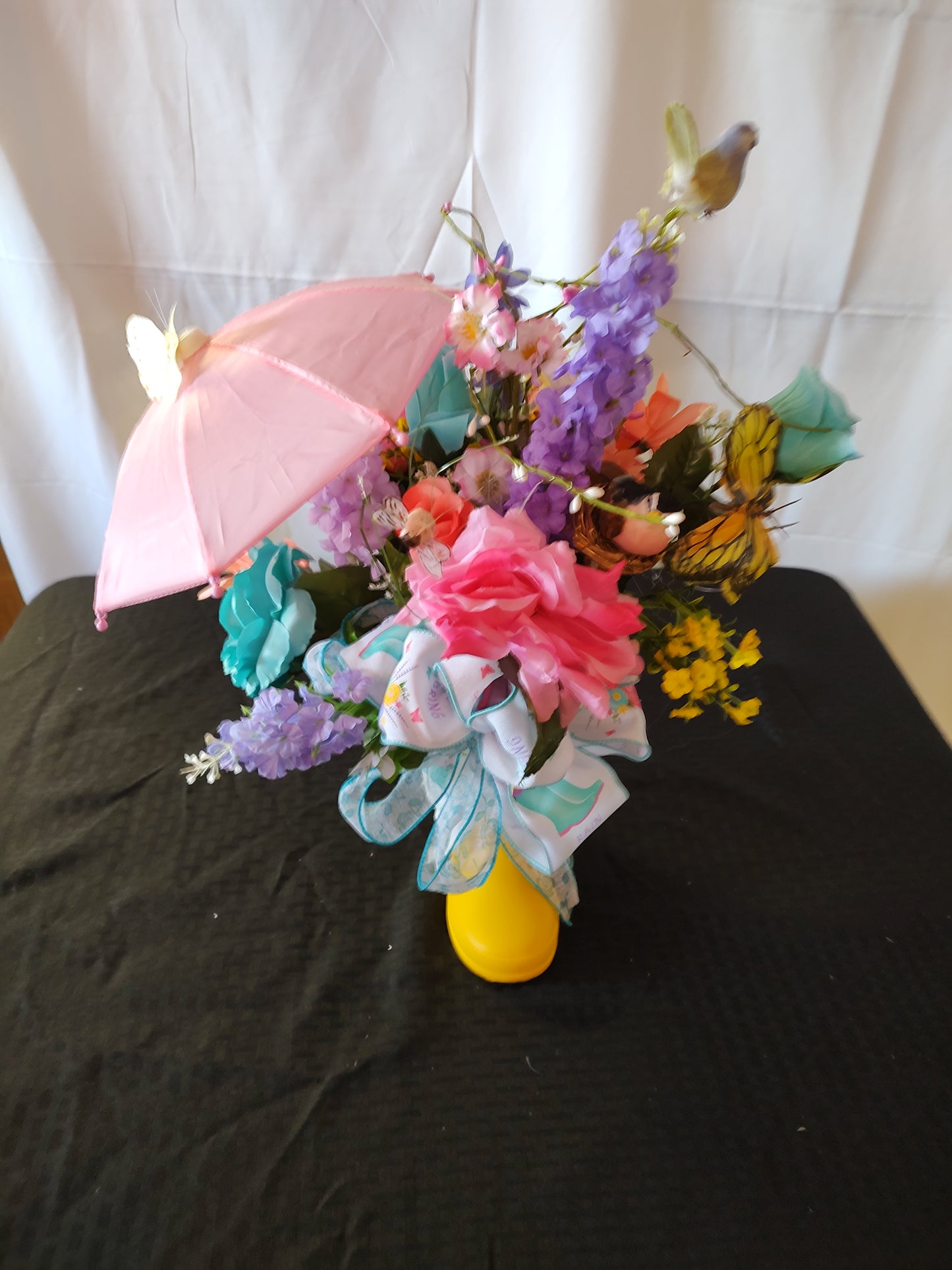 Spring rain boot umbrella centerpiece arrangement